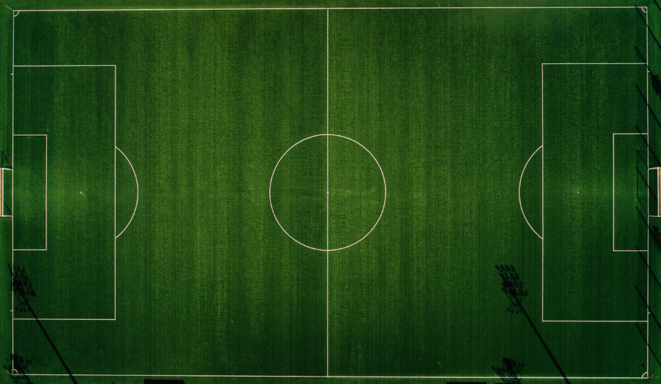 Photograph of an empty floodlit pitch
